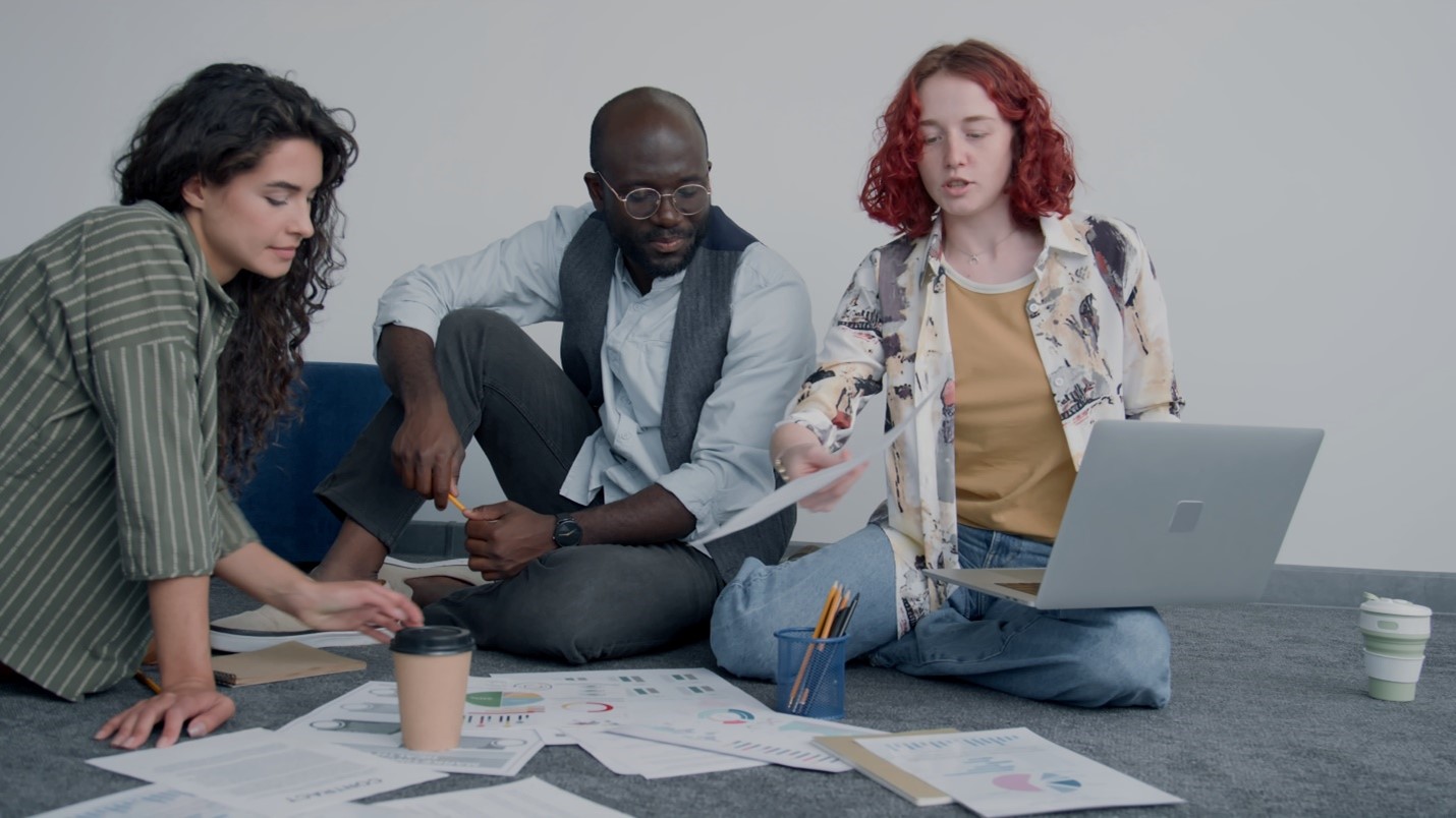 people gathered around a computer looking at data