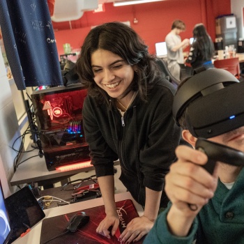 two students, one wearing a VR headset