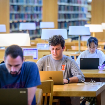 students studying in library with computers