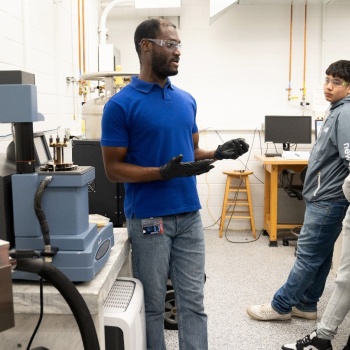 At left, Dr. Roddel Remy explains how the dynamical mechanical analysis tool works. (Photo by Heather Coit).