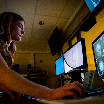 Person looking at screen with mri images of the human brain