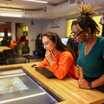 Two individuals use GenAI