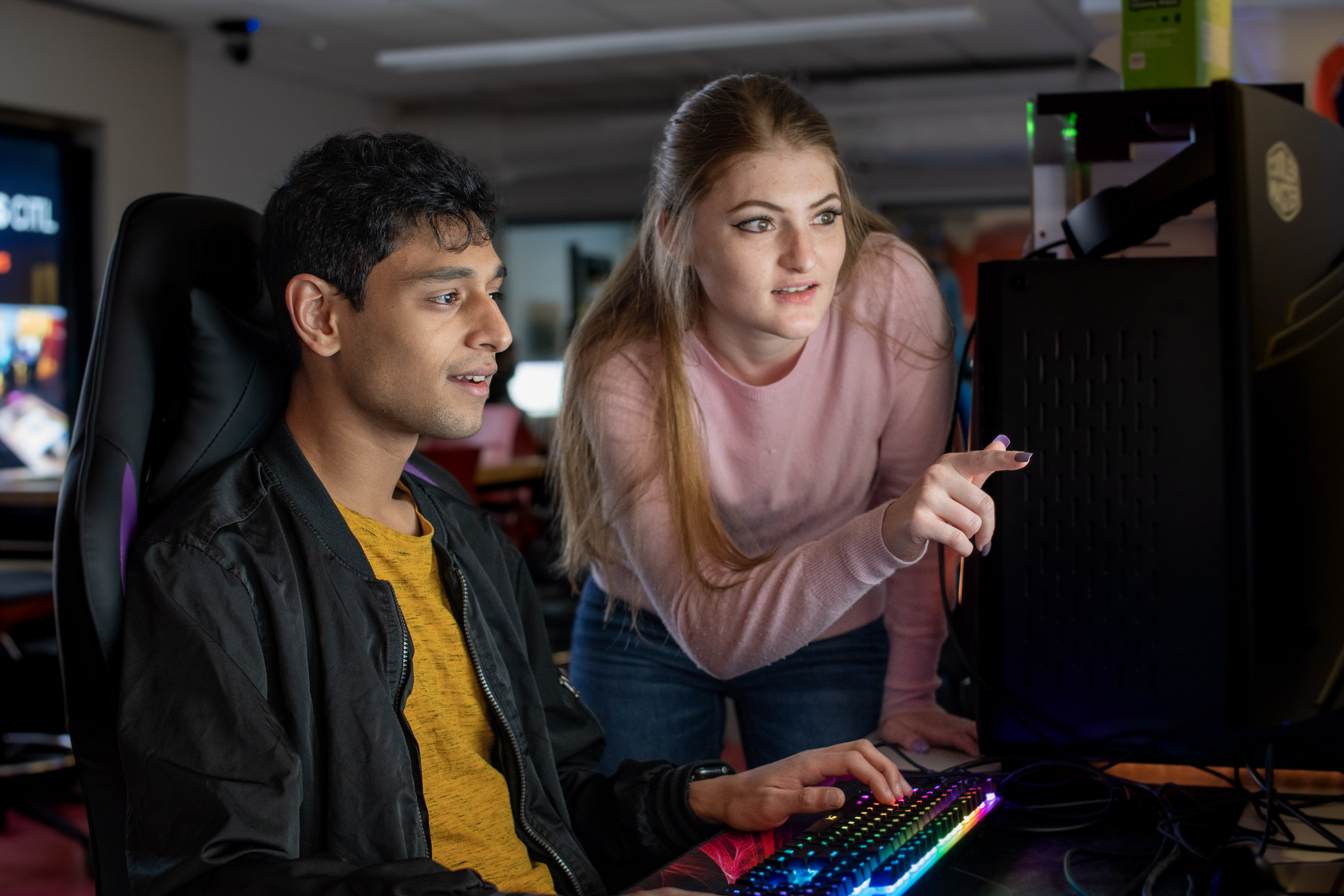 two students looking at a computer monitor