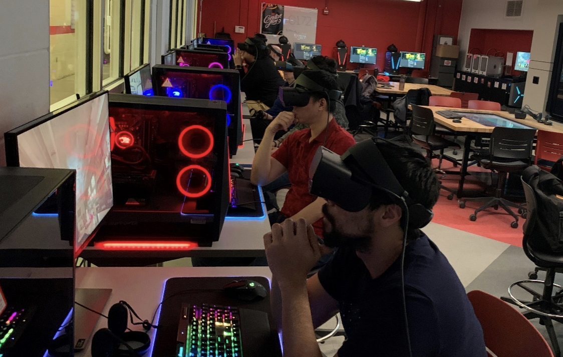 students wearing VR headsets sitting at computers in the Innovation Studio