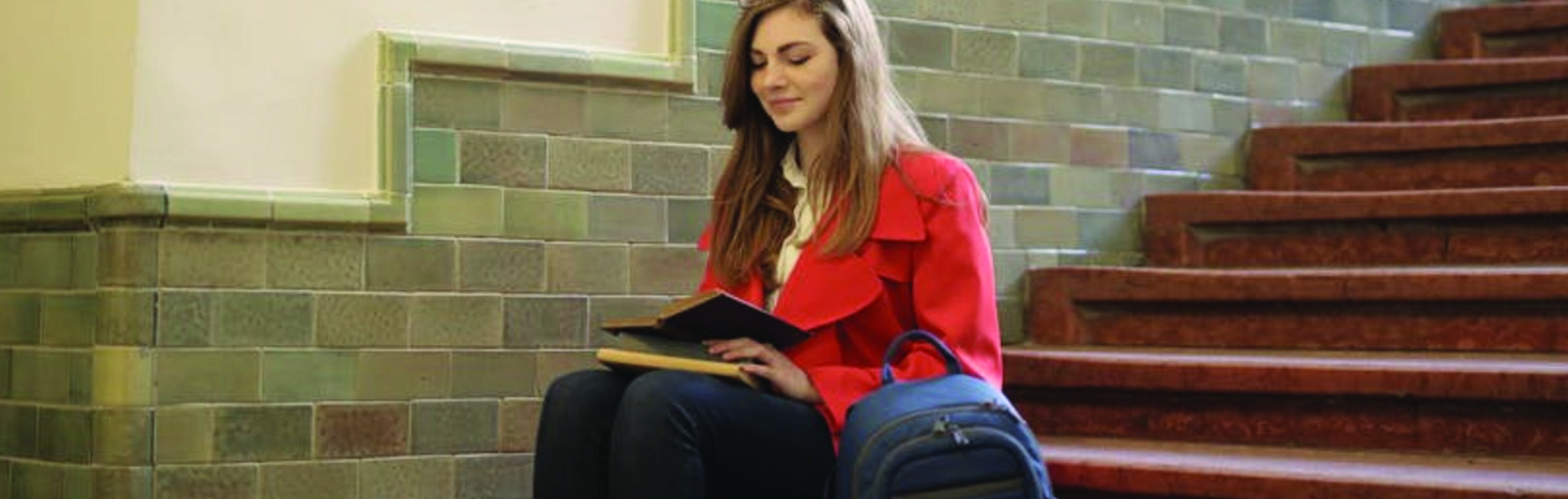 student-reading-a-book-on-stairs