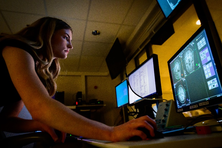 Person looking at screen with mri images of the human brain
