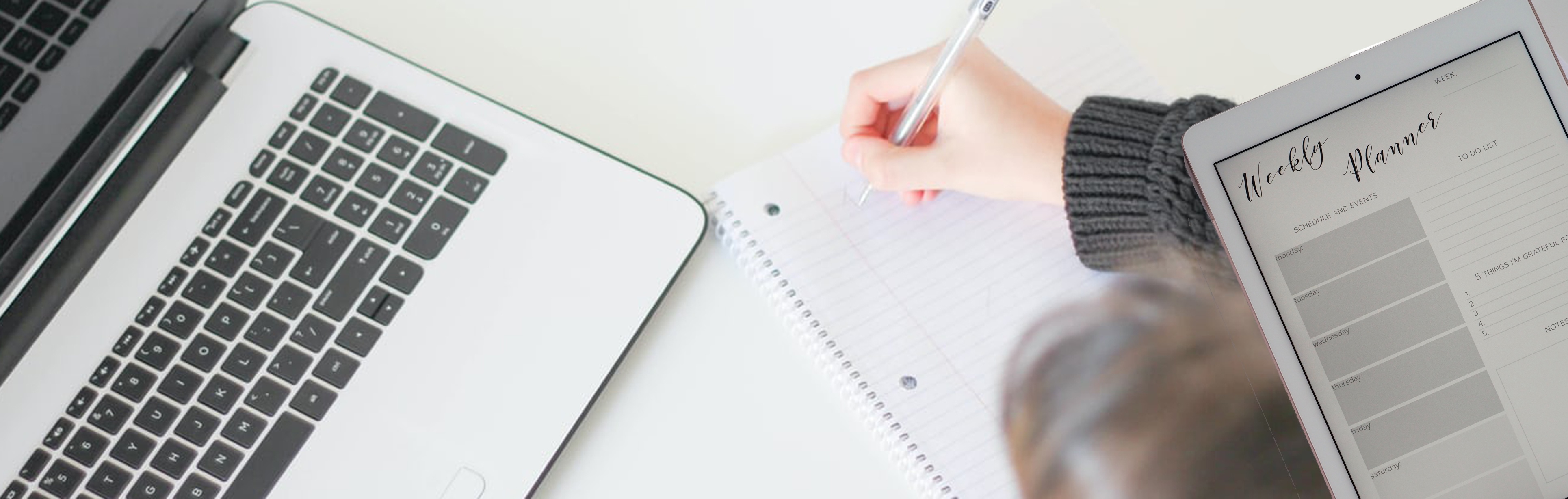 someone-taking-notes-with-their-weekly-planner-off-to-the-side